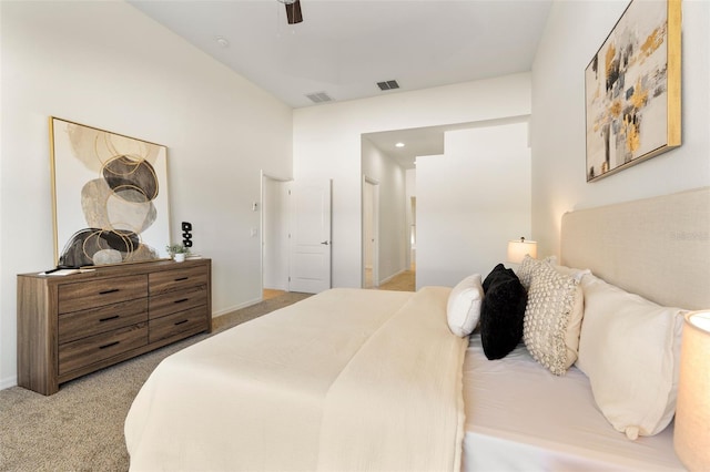 bedroom featuring visible vents, baseboards, and light colored carpet