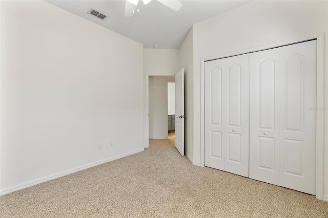 unfurnished bedroom featuring visible vents, ceiling fan, baseboards, light carpet, and a closet