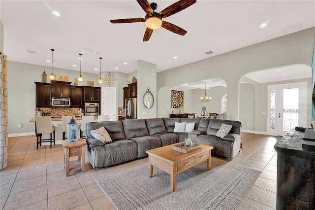 living room with arched walkways, visible vents, recessed lighting, and light tile patterned flooring