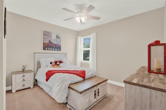 bedroom with ceiling fan, baseboards, and light carpet