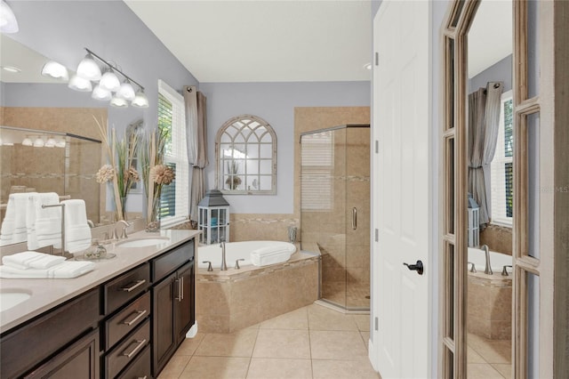 full bath featuring tile patterned flooring, a shower stall, and a sink