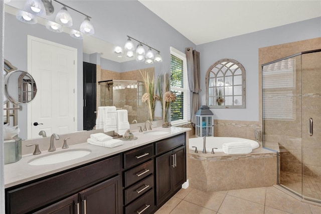 bathroom featuring a garden tub, tile patterned floors, a shower stall, and a sink