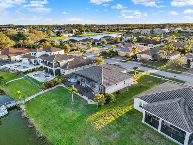 drone / aerial view with a residential view and a water view