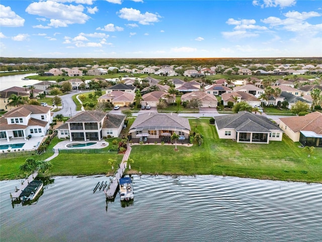 birds eye view of property with a residential view and a water view