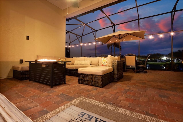 view of patio with an outdoor living space and glass enclosure