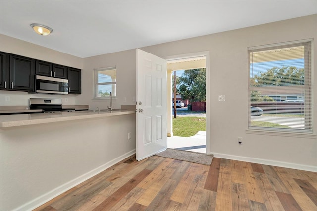 foyer featuring light wood-style flooring and baseboards