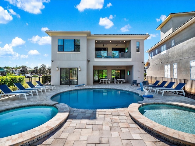 view of pool featuring a patio area, a pool with connected hot tub, ceiling fan, and fence