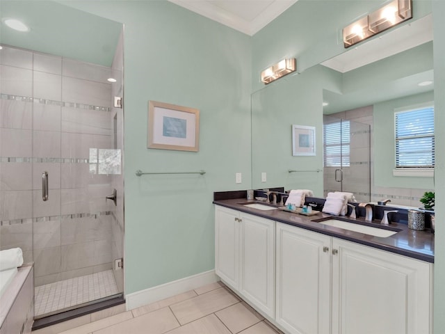 full bath with tile patterned flooring, double vanity, a stall shower, and a sink