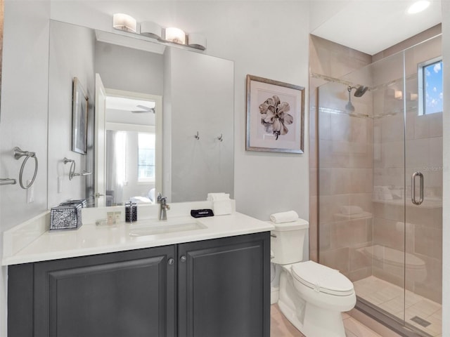 full bathroom featuring a shower stall, toilet, and vanity