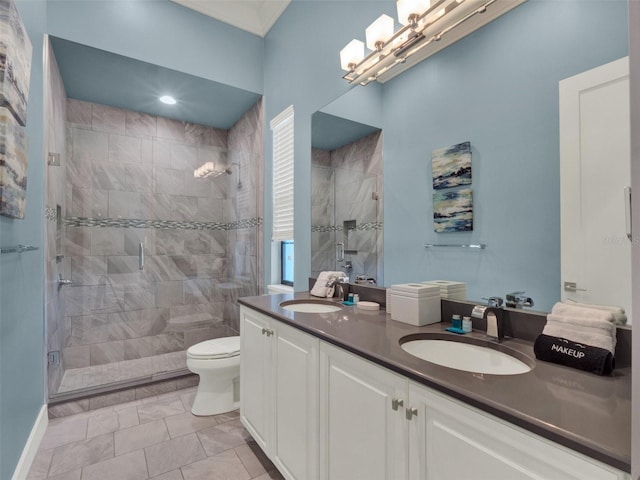 bathroom with double vanity, toilet, a stall shower, and a sink