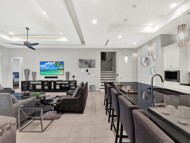 interior space with visible vents, ceiling fan, stairway, recessed lighting, and a raised ceiling