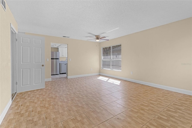 empty room featuring baseboards, visible vents, a textured ceiling, and a ceiling fan