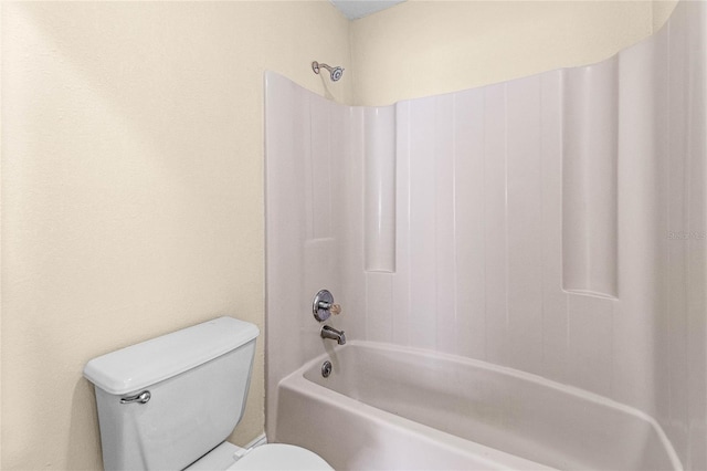 bathroom with toilet and washtub / shower combination