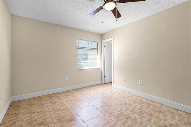 empty room featuring a textured ceiling, baseboards, and a ceiling fan