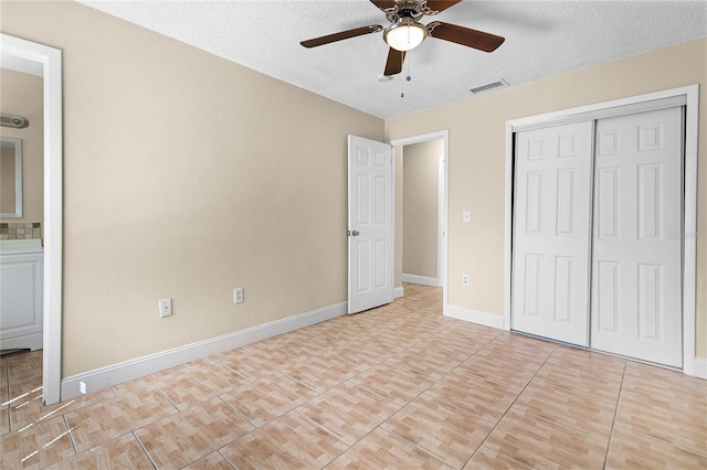 unfurnished bedroom featuring visible vents, ceiling fan, baseboards, a closet, and a textured ceiling