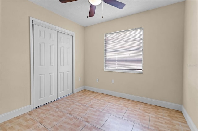 unfurnished bedroom featuring a closet, baseboards, and light tile patterned flooring