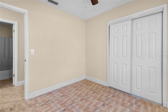 unfurnished bedroom with a ceiling fan, visible vents, a closet, and baseboards