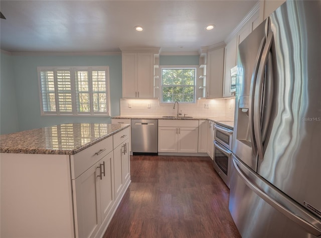 kitchen with open shelves, dark wood-type flooring, decorative backsplash, stainless steel appliances, and a sink