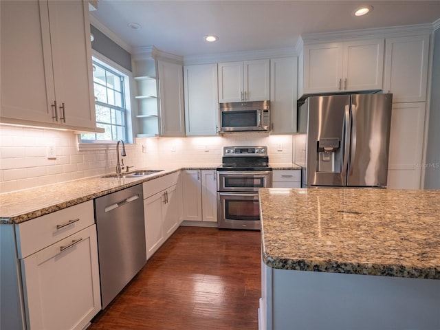 kitchen featuring a sink, decorative backsplash, open shelves, and stainless steel appliances