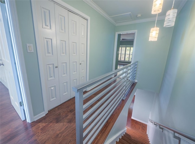 staircase featuring crown molding, baseboards, and wood finished floors