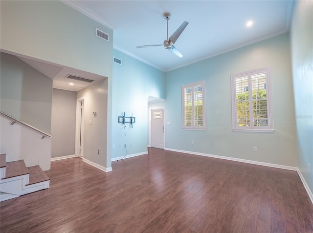 unfurnished living room with crown molding, wood finished floors, visible vents, and baseboards