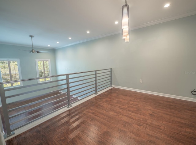 unfurnished room with recessed lighting, ornamental molding, baseboards, and wood finished floors