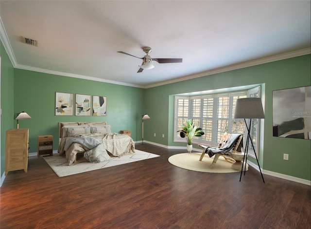 bedroom with visible vents, baseboards, wood finished floors, and ornamental molding