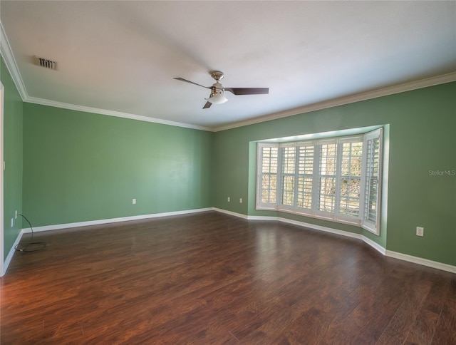 spare room with crown molding, wood finished floors, baseboards, and ceiling fan