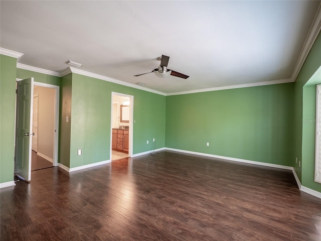 spare room featuring wood finished floors, baseboards, and ornamental molding