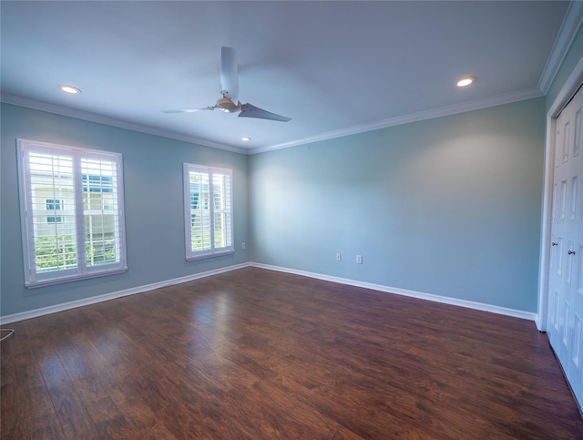 spare room featuring baseboards, dark wood-style flooring, and ornamental molding