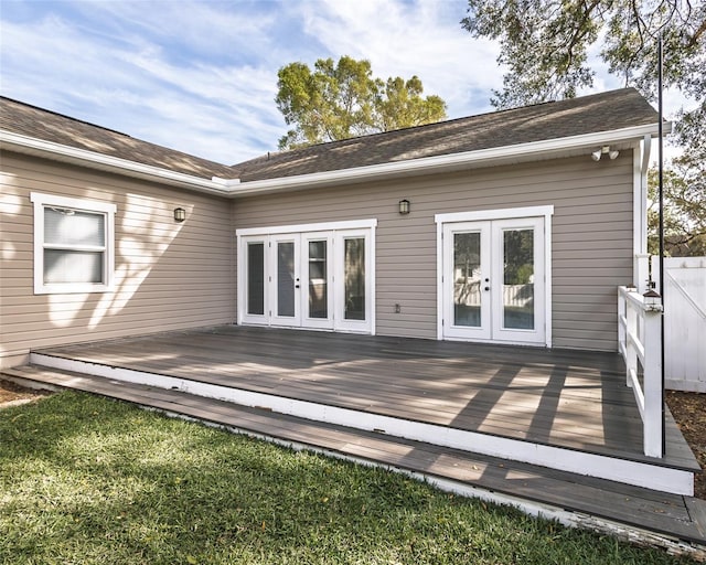 rear view of house featuring french doors, a wooden deck, and fence