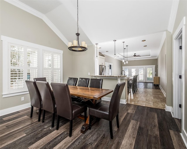 dining area with baseboards, lofted ceiling, dark wood-style floors, and ornamental molding