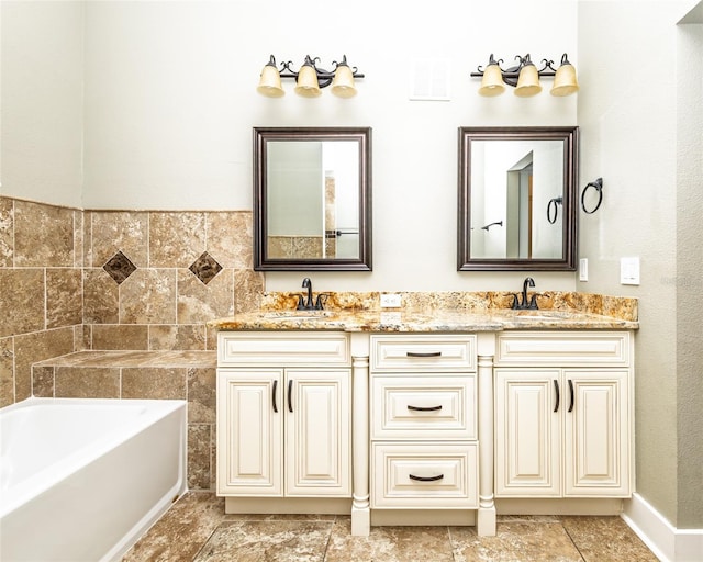 full bathroom featuring a sink, a bath, and double vanity