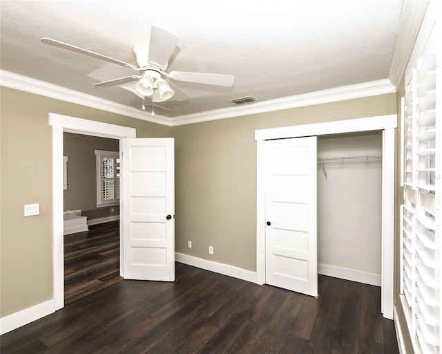 unfurnished bedroom featuring visible vents, baseboards, and dark wood-type flooring