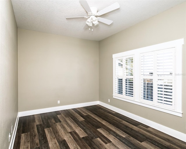 empty room with baseboards, a textured ceiling, dark wood-style floors, and a ceiling fan