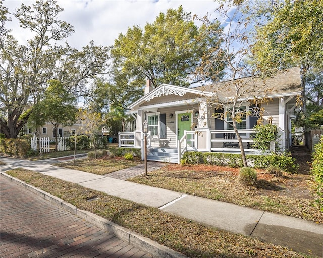 view of front of property featuring a porch and a chimney