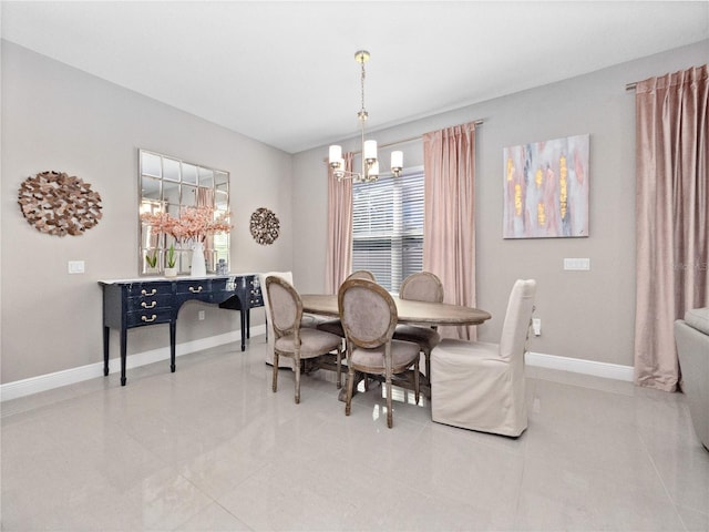 dining area with a notable chandelier and baseboards