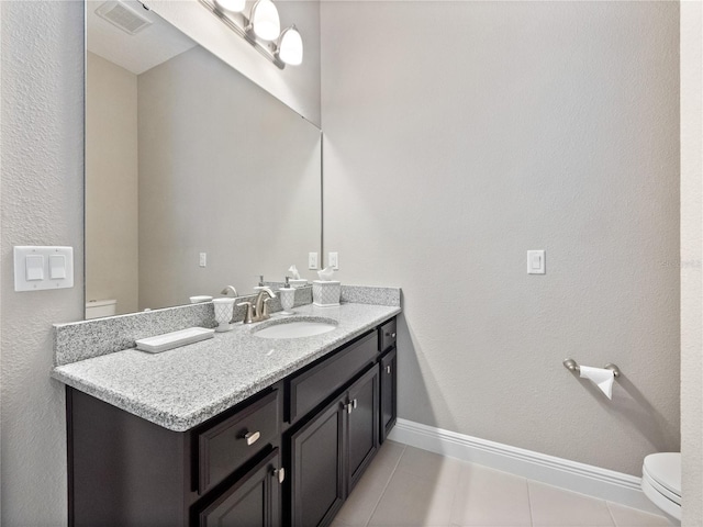 bathroom with visible vents, baseboards, toilet, tile patterned floors, and vanity