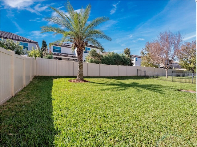 view of yard with a fenced backyard