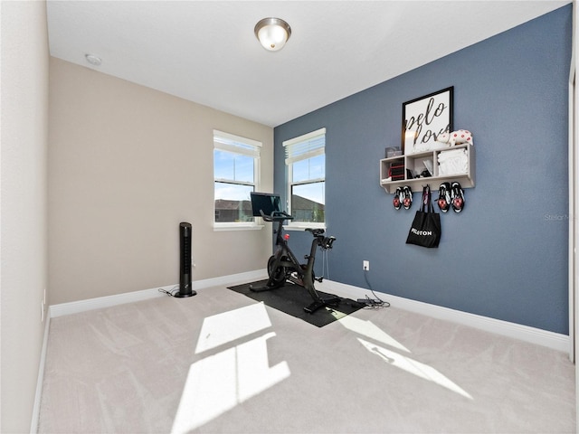 workout area featuring carpet and baseboards