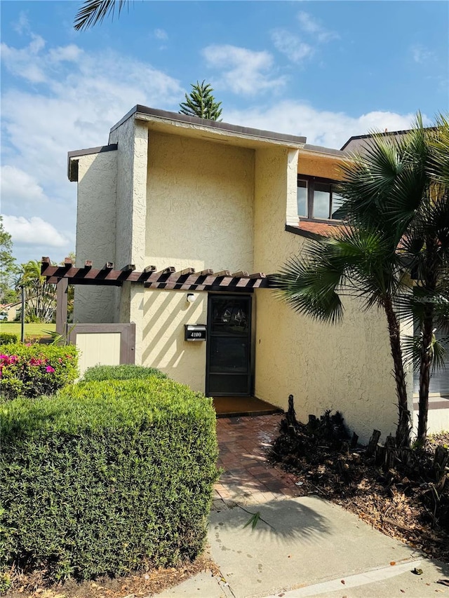 doorway to property with stucco siding