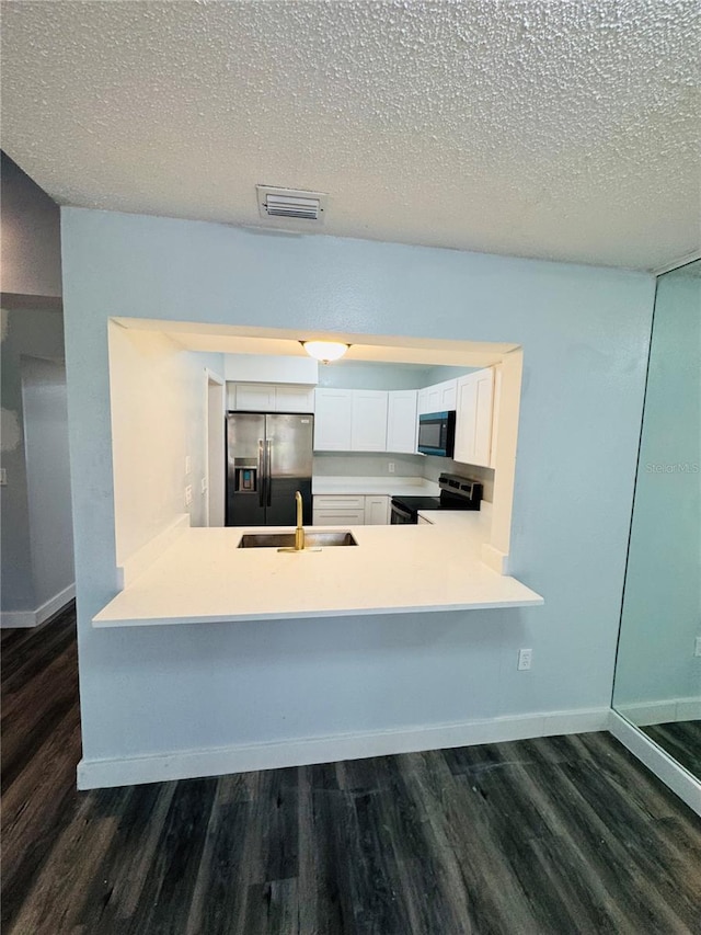 4100 Player Cir Unit 101, Orlando, FL 32808 - kitchen with dark wood-style floors, visible vents, appliances with stainless steel finishes, and a sink