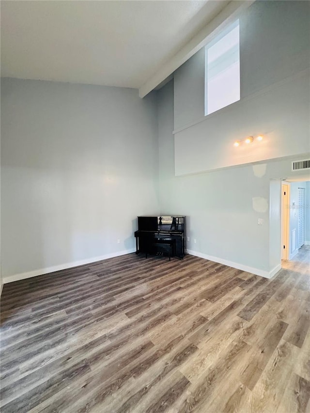 4100 Player Cir Unit 101, Orlando, FL 32808 - interior space featuring visible vents, a towering ceiling, baseboards, and wood finished floors