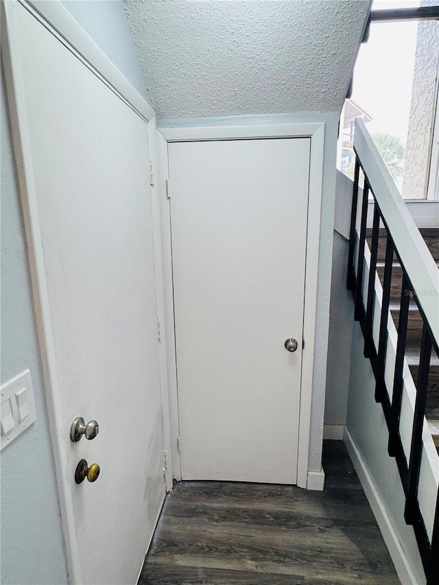 4100 Player Cir Unit 101, Orlando, FL 32808 - interior space with stairway, baseboards, dark wood-style flooring, and a textured ceiling