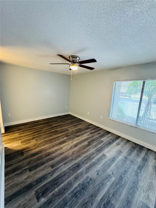 4100 Player Cir Unit 101, Orlando, FL 32808 - unfurnished room featuring baseboards, a textured ceiling, ceiling fan, and dark wood-style flooring