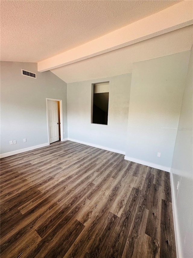 4100 Player Cir Unit 101, Orlando, FL 32808 - unfurnished room with visible vents, lofted ceiling with beams, a textured ceiling, dark wood-style floors, and baseboards