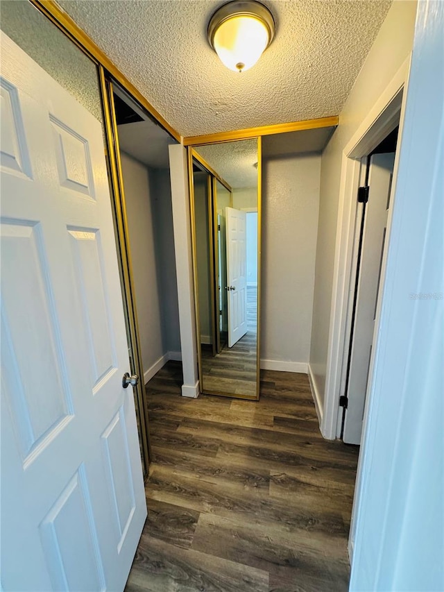 4100 Player Cir Unit 101, Orlando, FL 32808 - hall featuring a textured ceiling, baseboards, and dark wood-style flooring