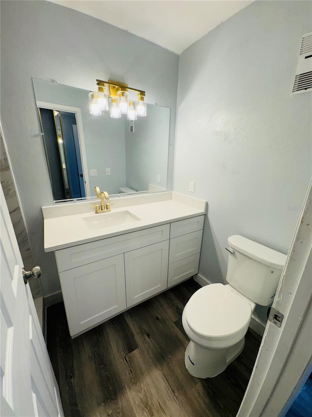 4100 Player Cir Unit 101, Orlando, FL 32808 - bathroom featuring vanity, toilet, and wood finished floors