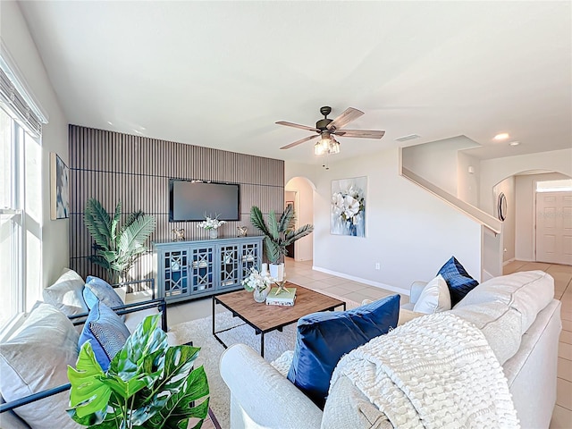 3279 Landing Vw, Tavares, FL 32778 - tiled living room with arched walkways, a ceiling fan, and visible vents