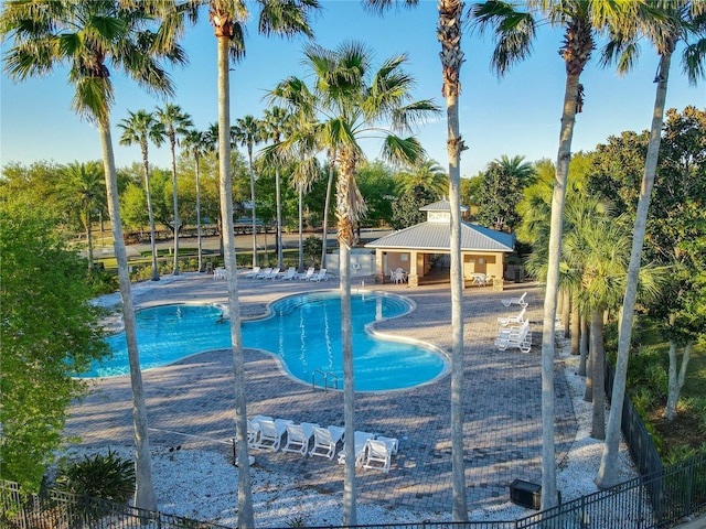 3279 Landing Vw, Tavares, FL 32778 - community pool featuring a storage structure, a patio, fence, and an outdoor structure
